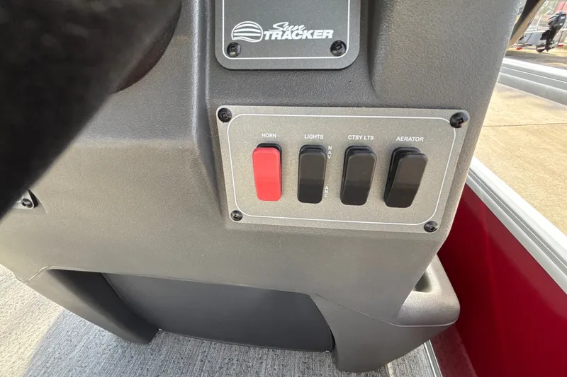 Slide: The Image of Control panel of 2026 Sun Tracker Bass Buggy 18 DLX with switches for horn, lights, and aerator. - 19