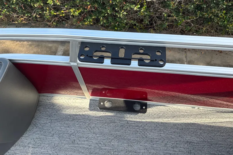 Slide: The Image of 2026 Sun Tracker Bass Buggy 18 DLX pontoon boat interior detail with red paneling. - 37