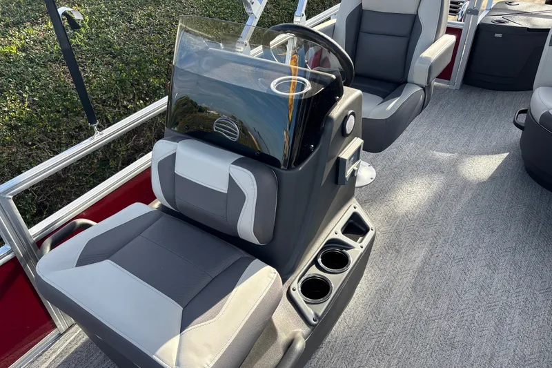 Slide: The Image of 2026 Sun Tracker Bass Buggy 18 DLX interior with modern seating and steering console. - 13