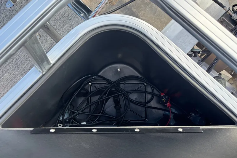 Slide: The Image of Storage compartment of 2026 Sun Tracker Bass Buggy 18 DLX with cables inside. - 30