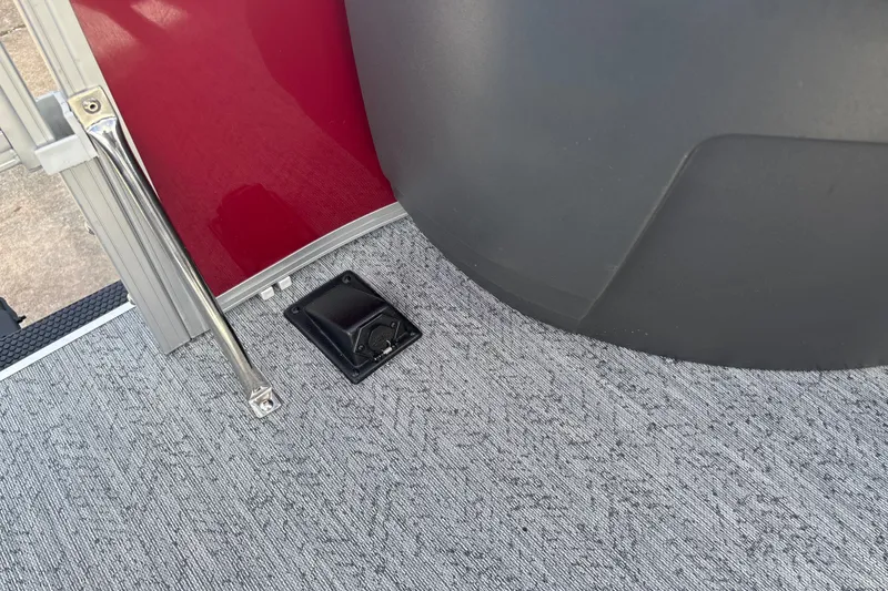 Slide: The Image of 2026 Sun Tracker Bass Buggy 18 DLX interior detail with red panel and carpeted floor. - 38