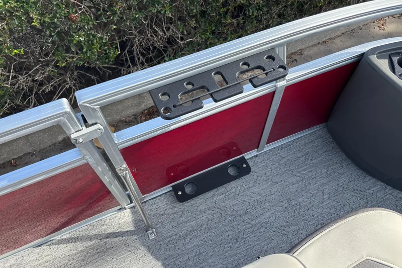 Slide: The Image of 2026 Sun Tracker Bass Buggy 18 DLX boat interior with red paneling and cup holders. - 34