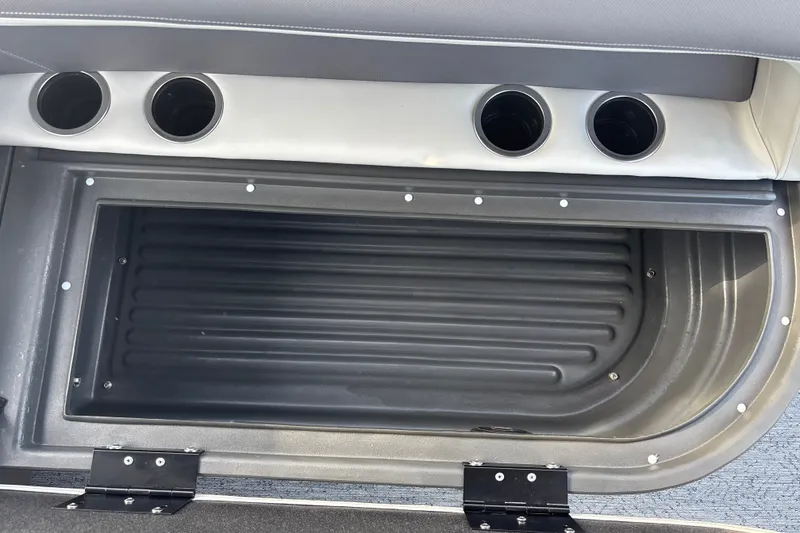 Slide: The Image of Interior storage compartment of 2026 Sun Tracker Bass Buggy 18 DLX with cup holders. - 32