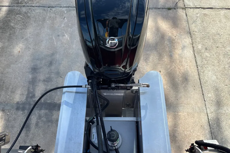 Slide: The Image of 2026 Sun Tracker Bass Buggy 18 DLX boat engine, top view on concrete surface. - 40