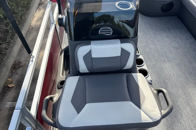 Slide: The Image of 2026 Sun Tracker Bass Buggy 18 DLX boat seat with cup holders and steering console. - 21