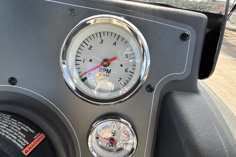 Slide: The Image of Close-up of RPM and fuel gauges on 2026 Sun Tracker Bass Buggy 18 DLX. - 18