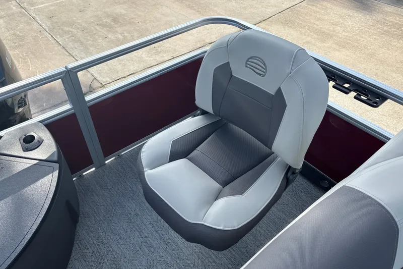 Slide: The Image of 2026 Sun Tracker Bass Buggy 18 DLX boat seat, gray and black upholstery, outdoor setting. - 14