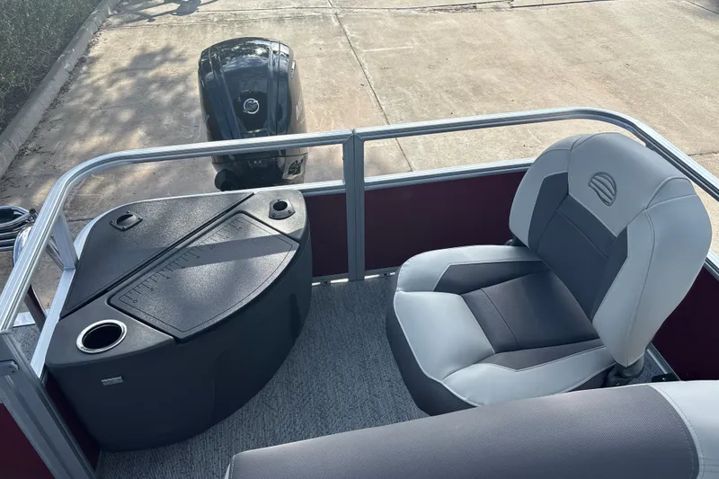 Slide: The Image of 2026 Sun Tracker Bass Buggy 18 DLX boat interior with seating and motor view. - 15