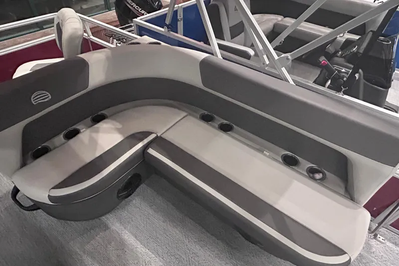 Slide: The Image of 2026 Sun Tracker Bass Buggy 18 DLX boat seating with cup holders and modern design. - 13