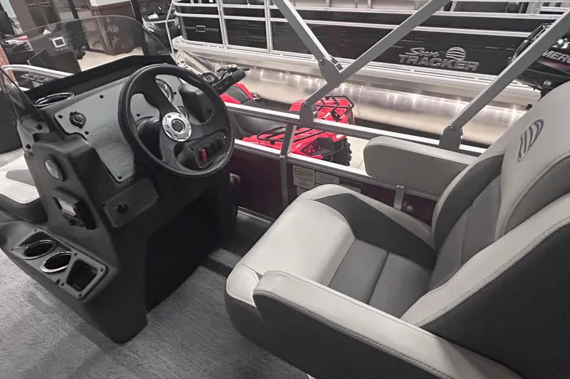 Slide: The Image of Interior view of 2026 Sun Tracker Bass Buggy 18 DLX pontoon boat with steering console. - 14