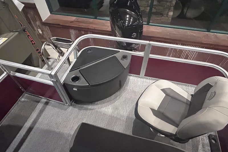 Slide: The Image of 2026 Sun Tracker Bass Buggy 18 DLX interior with seating and console. - 17