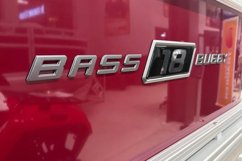 Slide: The Image of 2026 Sun Tracker Bass Buggy 18 DLX logo on red background. - 2