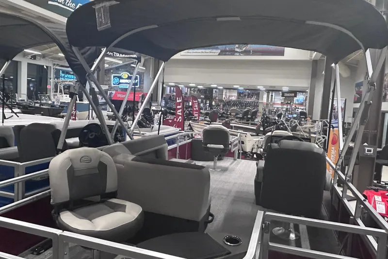 Slide: The Image of 2026 Sun Tracker Bass Buggy 18 DLX pontoon boat interior at showroom display. - 6