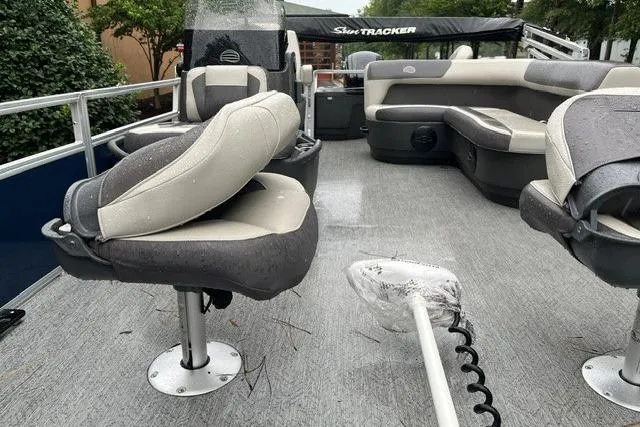 Slide: The Image of 2026 Sun Tracker Bass Buggy 18 DLX pontoon boat interior with seating and steering console. - 87
