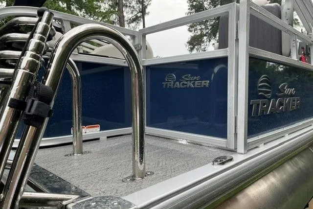 Slide: The Image of 2026 Sun Tracker Bass Buggy 18 DLX pontoon boat with sleek metal railings. - 7