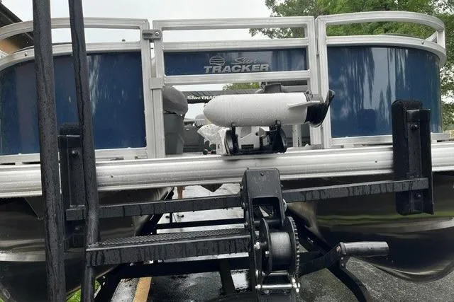 Slide: The Image of 2026 Sun Tracker Bass Buggy 18 DLX pontoon boat on trailer, rear view. - 2