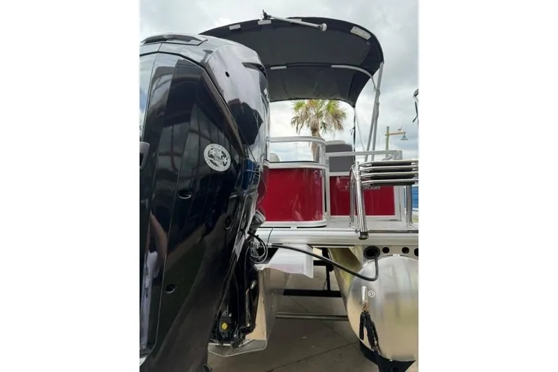 Slide: The Image of 2026 Sun Tracker Bass Buggy 18 DLX pontoon boat with outboard motor and canopy. - 4