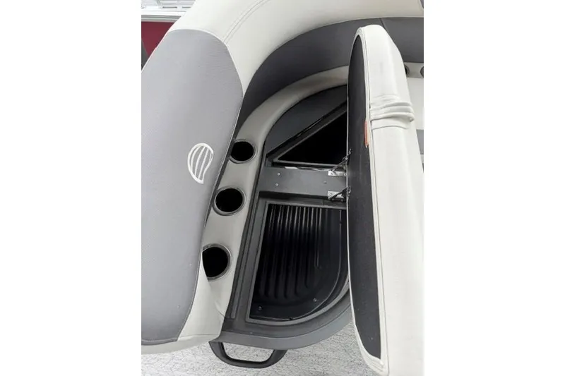 Slide: The Image of 2026 Sun Tracker Bass Buggy 18 DLX boat seat storage compartment with cup holders. - 14