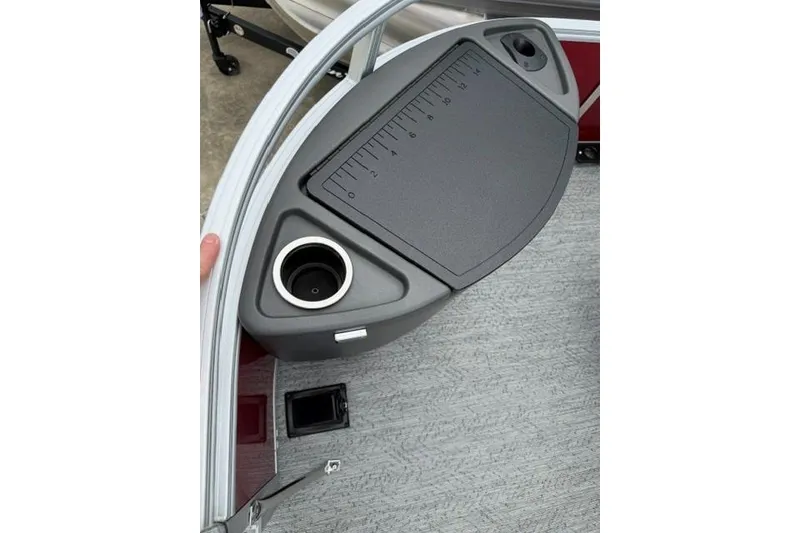Slide: The Image of 2026 Sun Tracker Bass Buggy 18 DLX boat console with cup holder and measuring board. - 11