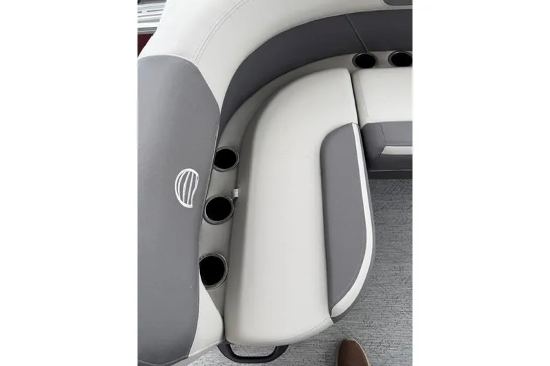 Slide: The Image of 2026 Sun Tracker Bass Buggy 18 DLX boat seating with cup holders, featuring gray and white upholstery. - 13