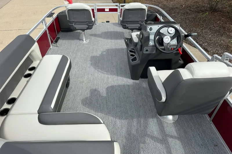 Slide: The Image of 2026 Sun Tracker Bass Buggy 18 DLX pontoon boat interior with seating and steering console. - 3