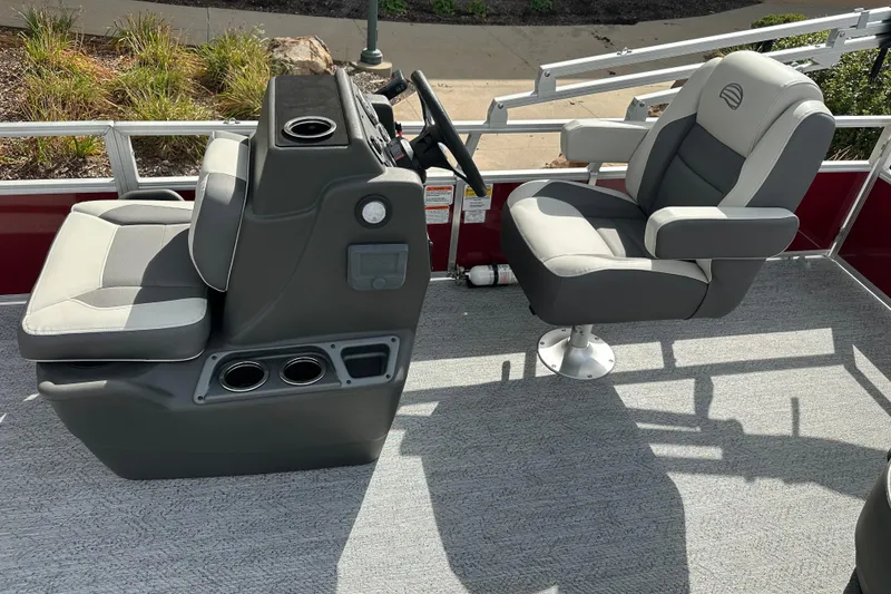 Slide: The Image of 2026 Sun Tracker Bass Buggy 18 DLX boat interior with steering console and seating. - 6