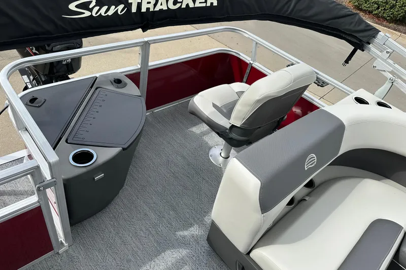 Slide: The Image of 2026 Sun Tracker Bass Buggy 18 DLX pontoon boat interior with seating and console. - 8