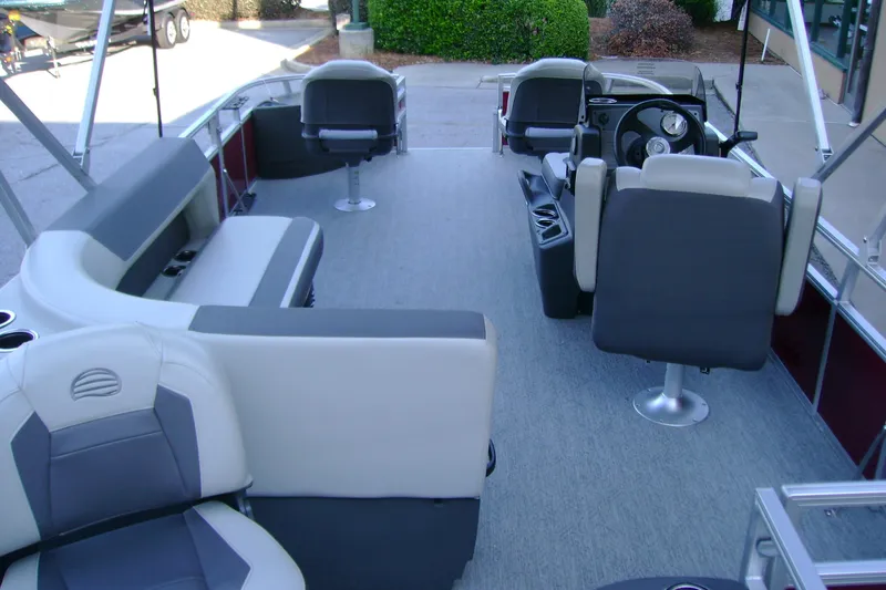 Slide: The Image of 2026 Sun Tracker Bass Buggy 18 DLX interior with seating and steering console. - 6
