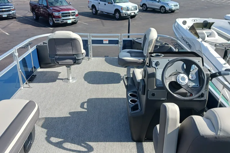 Slide: The Image of 2026 Sun Tracker Bass Buggy 18 DLX pontoon boat interior with seating and steering console. - 15
