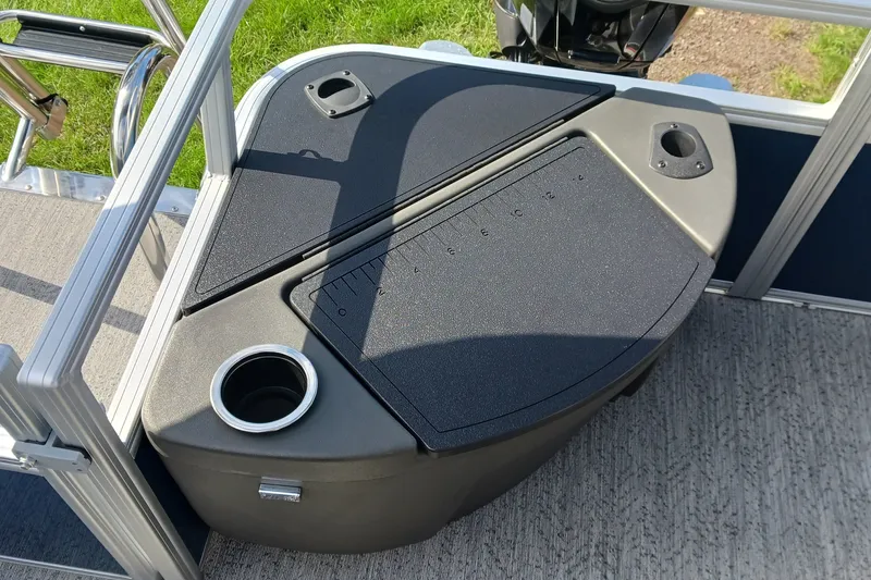 Slide: The Image of 2026 Sun Tracker Bass Buggy 18 DLX boat deck with cup holder and storage compartment. - 12