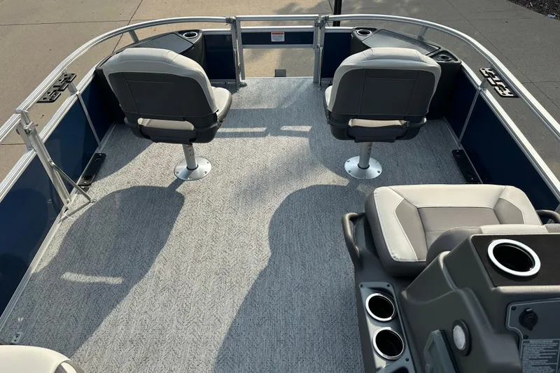 Slide: The Image of 2026 Sun Tracker Bass Buggy 18 DLX pontoon boat interior with seating and console. - 3