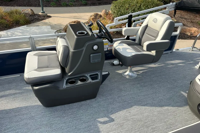 Slide: The Image of 2026 Sun Tracker Bass Buggy 18 DLX interior with two gray seats and console. - 5
