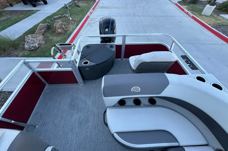 Slide: The Image of 2026 Sun Tracker Bass Buggy 18 DLX pontoon boat interior with seating and motor. - 17
