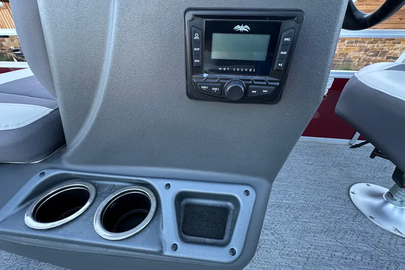 Slide: The Image of 2026 Sun Tracker Bass Buggy 18 DLX console with stereo system and cup holders. - 22