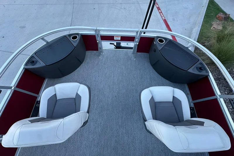 Slide: The Image of 2026 Sun Tracker Bass Buggy 18 DLX pontoon boat interior with seating and storage compartments. - 25