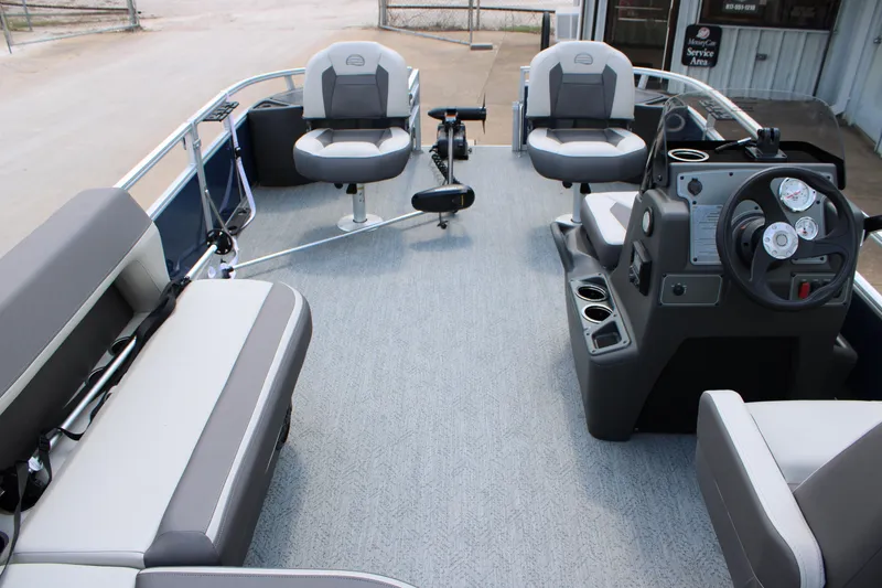 Slide: The Image of 2026 Sun Tracker Bass Buggy 18 DLX pontoon boat interior with seating and steering console. - 12