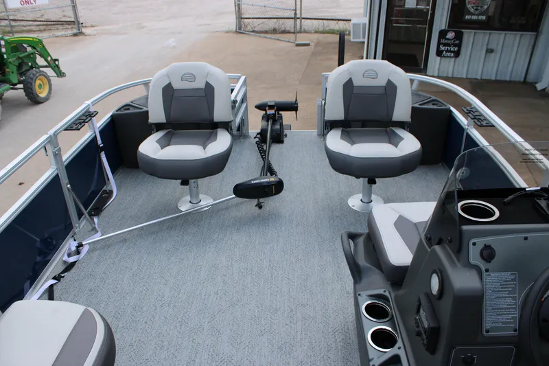Slide: The Image of 2026 Sun Tracker Bass Buggy 18 DLX pontoon boat interior with seating and controls. - 6