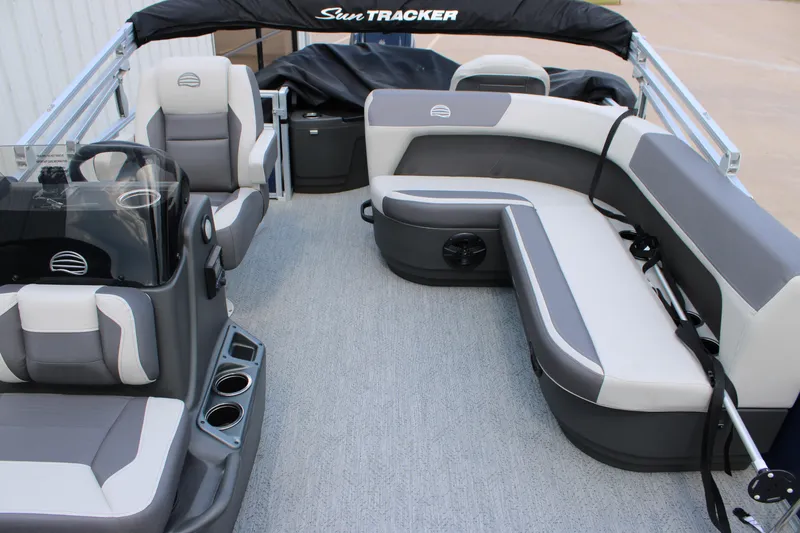 Slide: The Image of 2026 Sun Tracker Bass Buggy 18 DLX interior with gray seating and steering console. - 10