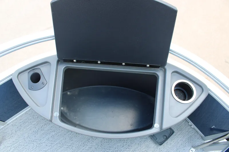 Slide: The Image of 2026 Sun Tracker Bass Buggy 18 DLX storage compartment with cup holder and accessory slot. - 8