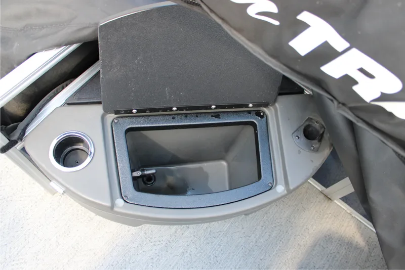 Slide: The Image of 2026 Sun Tracker Bass Buggy 18 DLX boat storage compartment with cup holder. - 11