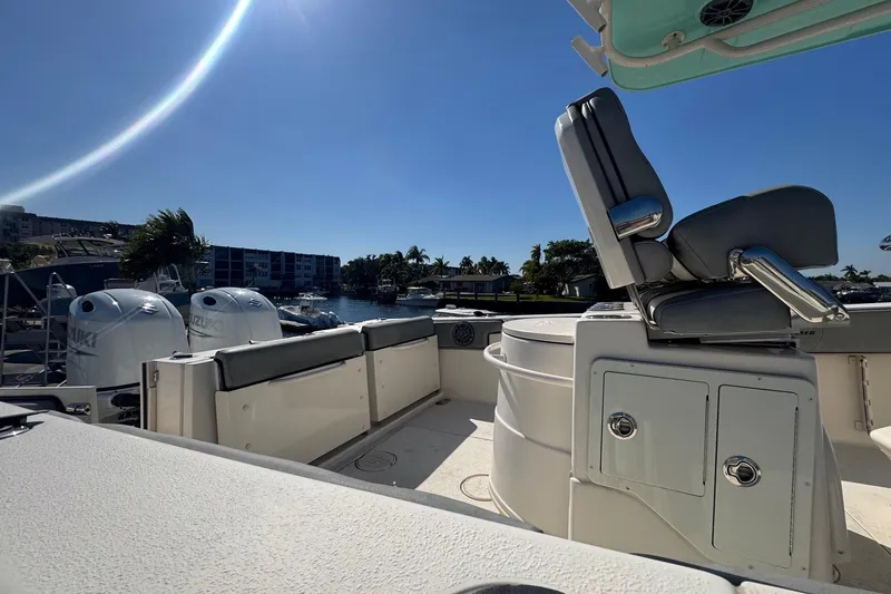 Slide: The Image of 2023 Sea Chaser 27 HFC CC boat interior with seating and dual Suzuki engines. - 10