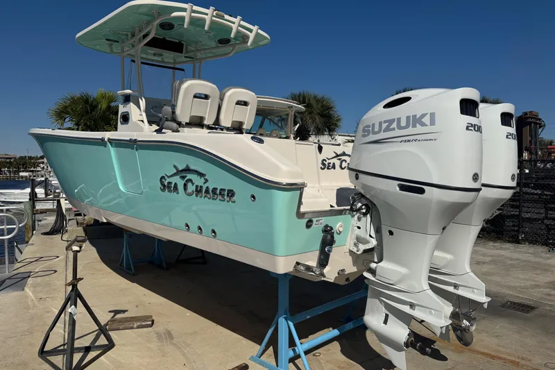 Slide: The Image of 2023 Sea Chaser 27 HFC CC boat with dual Suzuki engines on display. - 2