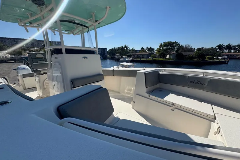 Slide: The Image of 2023 Sea Chaser 27 HFC CC boat interior with seating and water view. - 5
