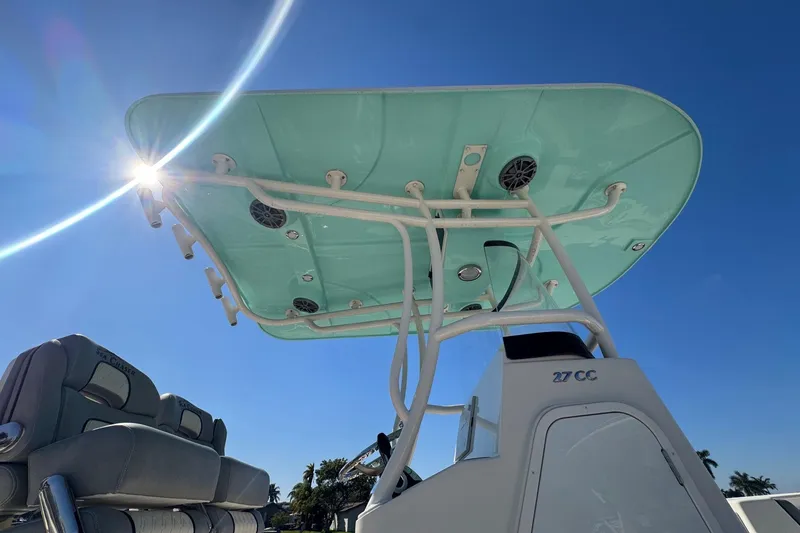 Slide: The Image of 2023 Sea Chaser 27 HFC CC boat with sunlit T-top against clear blue sky. - 6