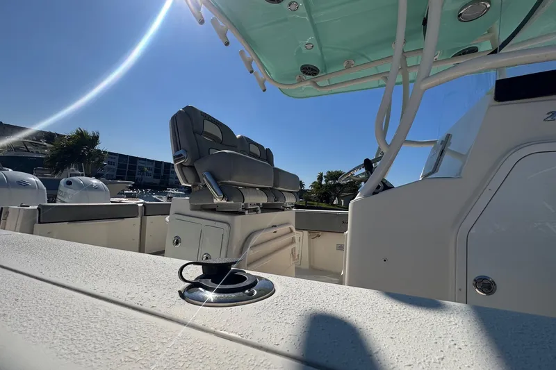 Slide: The Image of 2023 Sea Chaser 27 HFC CC boat interior with seating and console under clear blue sky. - 8