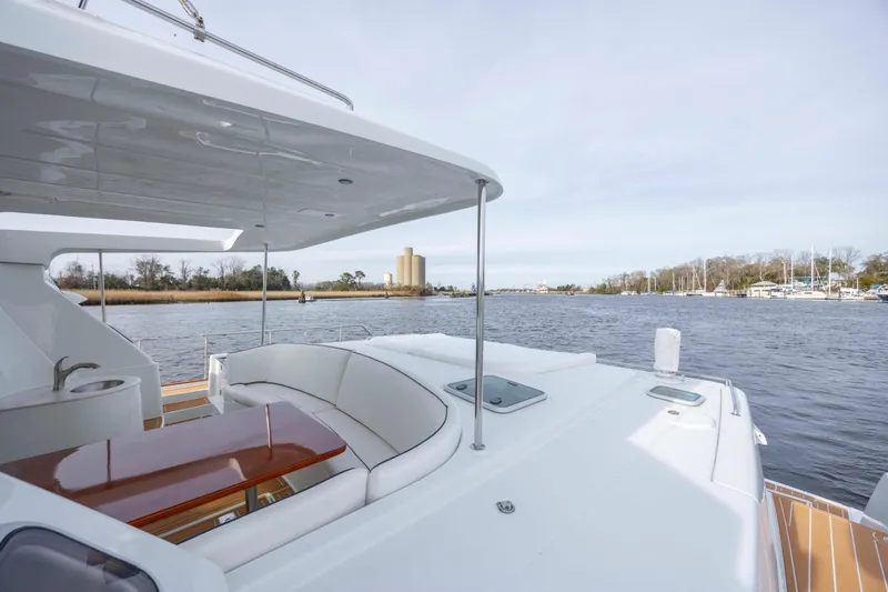 Slide: The Image of 2004 Lagoon 43 PC yacht with spacious deck and scenic waterway view. - 15