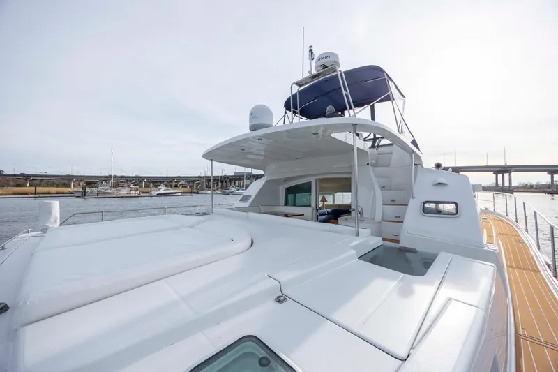 Slide: The Image of 2004 Lagoon 43 PC yacht with spacious deck and flybridge, docked near a marina. - 18