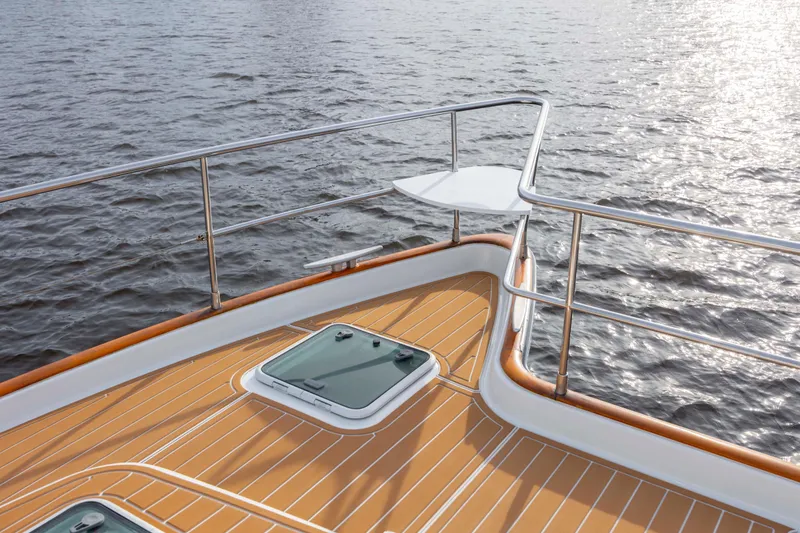 Slide: The Image of Deck view of 2004 Lagoon 43 PC yacht with wooden finish and ocean backdrop. - 24