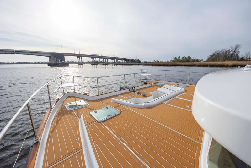 Slide: The Image of 2004 Lagoon 43 PC yacht deck with scenic river and bridge view. - 25