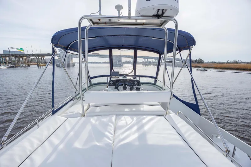 Slide: The Image of 2004 Lagoon 43 PC yacht with blue canopy on calm water. - 29